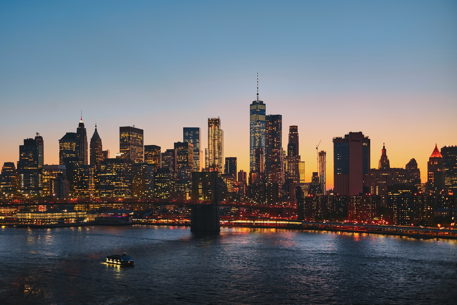 Lower Manhattan skyline and One World Trade Center at sunset, viewed across the East River. Title Lower Manhattan Skyline | Pinpoint Lower Manhattan skyline and One World Trade Center at sunset, viewed across the East River.